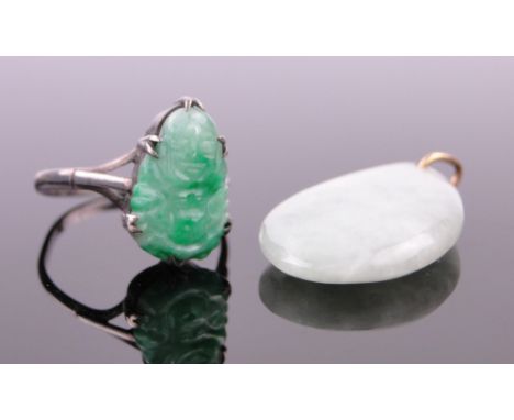 A Chinese silver ring,
with carved jade mount and a polished jade oval pendant, (2).