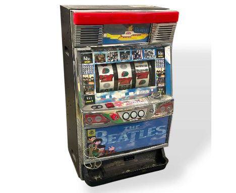 A Japanese made table top fruit machine with Beatles imagery, made by 'NET'. Approx 60cm tall. No key, separate transistor, s