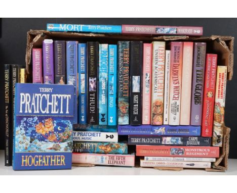 A large collection of Terry Pratchett books to include a signed hardback copy of the Hogfather and various first edition exam