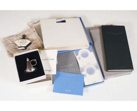 A small group of Concorde collectables to include a boxed food book, boxed notebook and a sterling silver candle snuffer toge