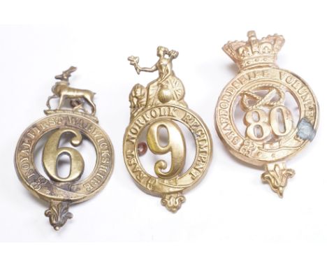 A collection of Three British Glengarry badges to include The East Norfolk Regiment, The Staffordshire Volunteer Regiment and