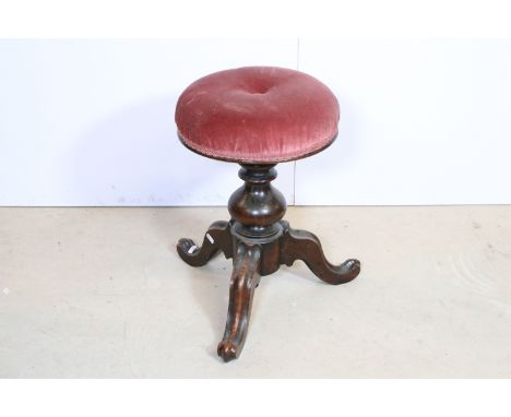 Victorian walnut circular pink upholstered adjustable piano stool on turned support and tripd base 