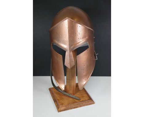 Metal replica of medieval Spartan helmet with wooden display stand, approx. H 48cm
