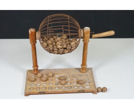 Vintage Bingo set with handled wired cage containing wooden balls and a board with corresponding numbers, H 25cm