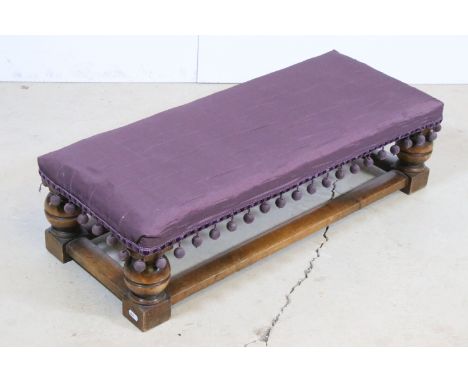 Early 20th century mahogany long ottoman/ low bench foot rest with turned legs, taffeta upholstered top and bobble trim H 22c
