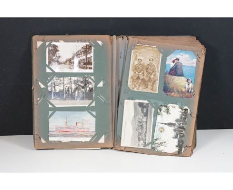 An antique postcard album complete with contents of early 20th century printed and real photo postcards to include a good sel