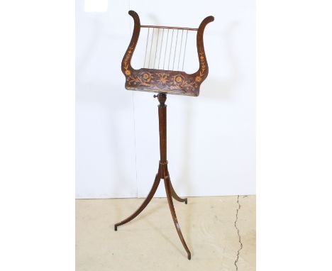 20th century mahogany music stand with inlaid floral and musical instrument detail, raised on tripod legs, H 117cm