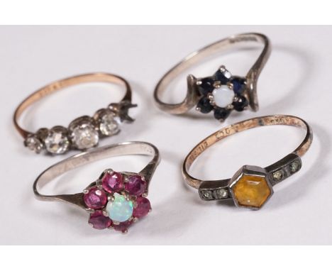 A collection of four sterling silver ladies dress rings. 
