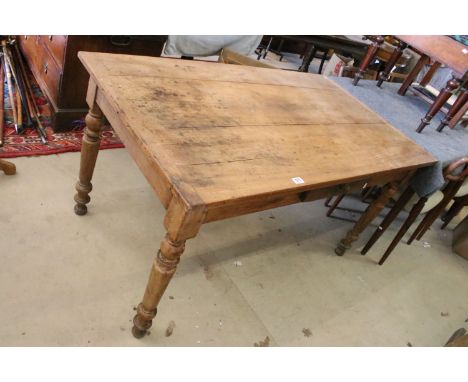 Early 20th century mixed wood large kitchen table with two pine extender leaves and small side drawer, raised on turned legs,