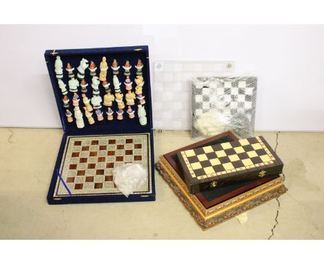 Collection of luxury chess sets, pieces and boards to include a ceramic version, crystal and glass set, perspex set, carved w