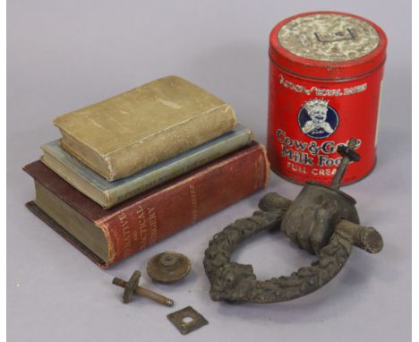 A vintage cast-iron door knocker, 15cm x 18.5cm; a vintage Cow &amp; Gate “Milk Food” tin; &amp; three vintage medical books.