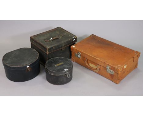 A vintage japanned-metal hatbox, 26.5cm diameter; together with another hatbox; a tan leather suitcase; &amp; a fibre-covered