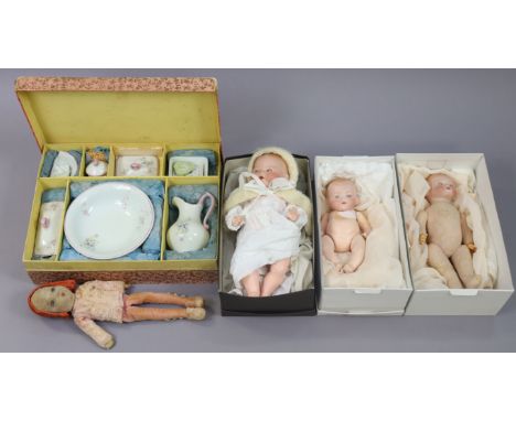 Three Armand Marjeille bisque-head baby dolls; a fabric doll; &amp; a doll’s tea set, boxed. 