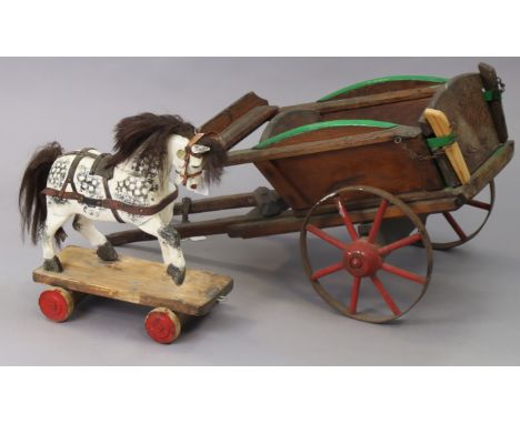 A painted wooden pull-along dapple-grey horse, 35cm wide x 41cm high; &amp; a painted wooden pull-along cart, 83cm wide x 36c