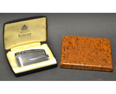 A Ronson Varaflame lighter, cased; an Art Deco Bakelite cigarette case, Birmingham 1856