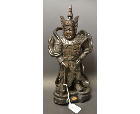 A carved Chinese wooden figure axe warrior, shaped base, character signature to front fan