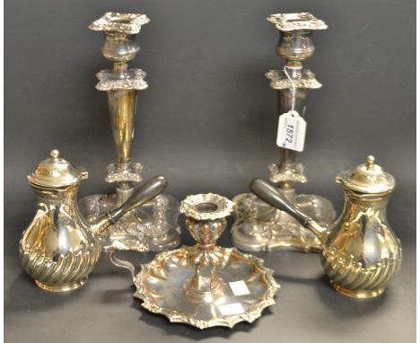 A pair of EPNS cafe au lait pots and covers; a pair of Sheffield plated candlesticks; a chamber stick (5)