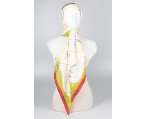 Hermès. Paris. Natural silk white cowl with a large bow at the neck, printed.Has had considerable wear.Vintage.