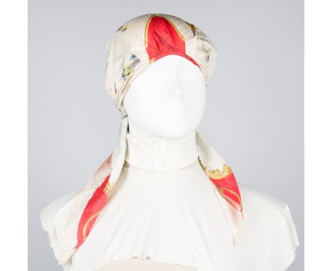 Hermès. Paris. Natural silk white cowl with a bow at the neck, printed.Has had considerable wear.Vintage.