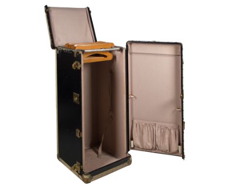 Large travel trunk made of wood, metal, leather, and gilded metal fittings. 1920s - 30s.Vintage.Vertical opening, with a larg