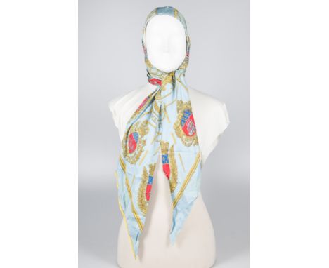 Hermès. Paris. Natural silk sky blue cowl with a large bow at the neck, printed.Shows wear and stains.Vintage.