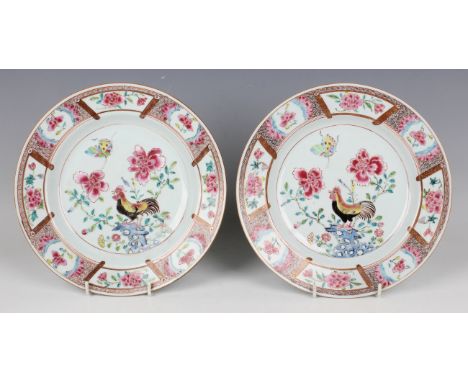 A pair of Chinese famille rose export porcelain plates, Yongzheng period, each painted with a cockerel perched on a rock bene