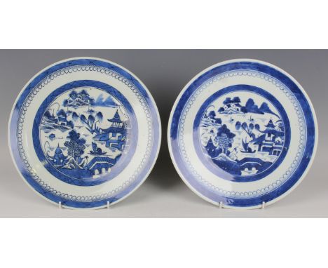 A pair of Chinese Canton blue and white porcelain circular dishes, late 19th century, each painted with a coastal landscape, 