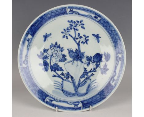 A Chinese blue and white porcelain circular dish, late Qing dynasty, painted with a bird and butterflies amidst rocks and peo