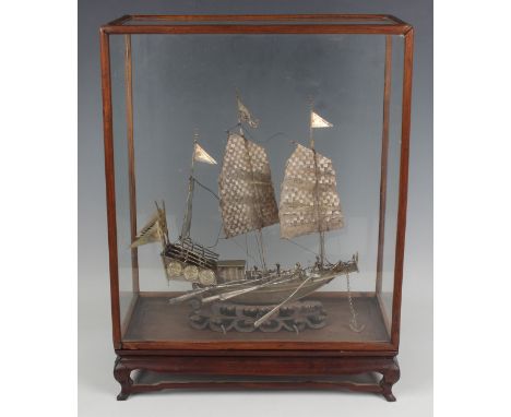 A Chinese silver and plated model of a naval gunship, early 20th century, mounted on a carved and pierced hardwood stand, hei