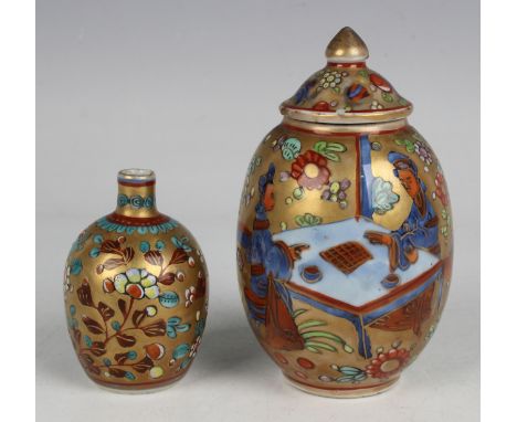 A Chinese 'clobbered' blue and white porcelain ovoid tea caddy and cover, Kangxi period and later, painted in underglaze blue