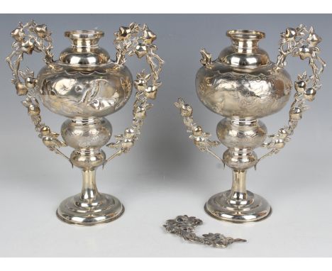 A pair of Chinese silver vases, early 20th century, each globular body decorated with a dragon or a bird on blossoming branch