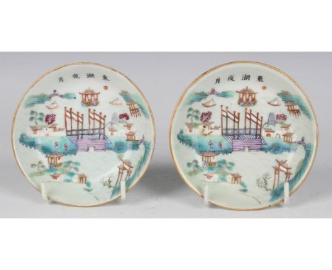 A pair of Chinese famille rose porcelain saucers, mark of Daoguang and possibly of the period, each painted with a coastal sc