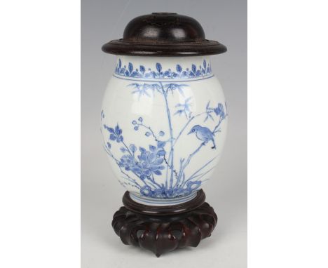 A Chinese Transitional blue and white porcelain jar, mid-17th century, the swollen ovoid body painted with two birds perched 