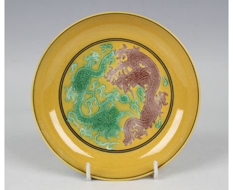 A Chinese yellow ground famille verte porcelain dragon saucer dish, mark of Xuantong but later, incised with two dragons cont