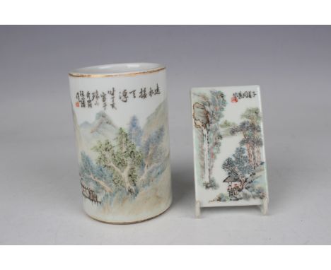 A Chinese porcelain brush pot, Republic period, painted with two pavilions and trees in a mountainous landscape, beneath line