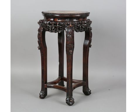 A Chinese hardwood stand, late 19th/early 20th century, the lobed top inset with a rouge marble panel within carved bead bord