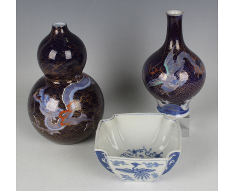 A Japanese Fukagawa porcelain double gourd vase, Meiji period, painted with a dragon against a ground of gilt overlapping wav