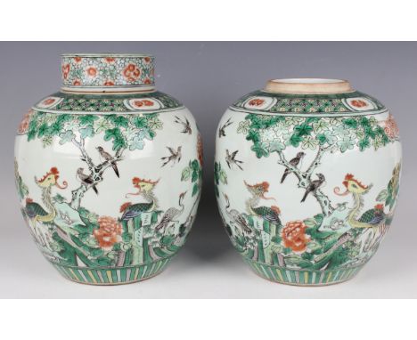 A pair of Chinese famille verte porcelain ginger jars and a cover, late 19th century, each stout ovoid body painted with a pa