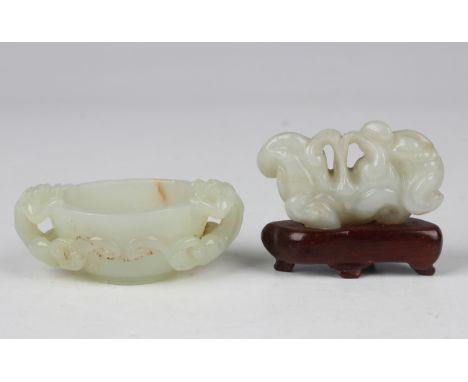 A Chinese pale celadon jade diminutive cup, probably late Qing dynasty, the circular tapered bowl carved and pierced with a p