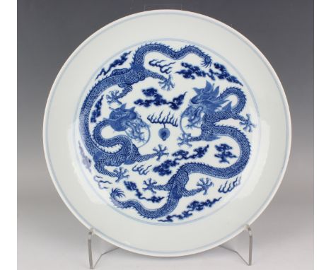 A Chinese blue and white porcelain circular dish, mark of Guangxu and possibly of the period, the interior painted with a pai