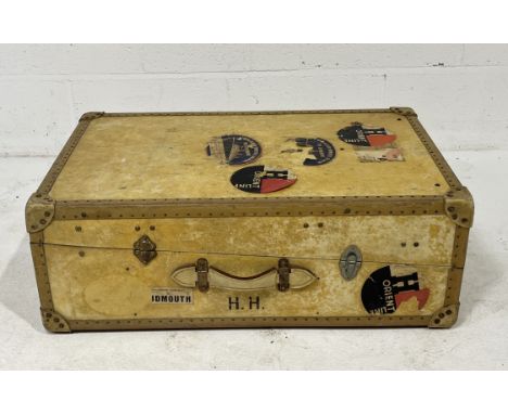 An early 20th century vellum wardrobe steamer trunk with various labels including Cunard White Star and The Orient Line
