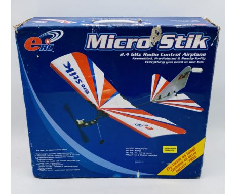 A boxed ERC Mirco Stik 2.4 GHz radio control airplane with controller and instruction leaflet
