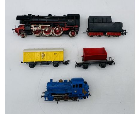 A small collection of unboxed Marklin OO gauge model railway including a 2-6-2 steam locomotive (23014) with tender in black 