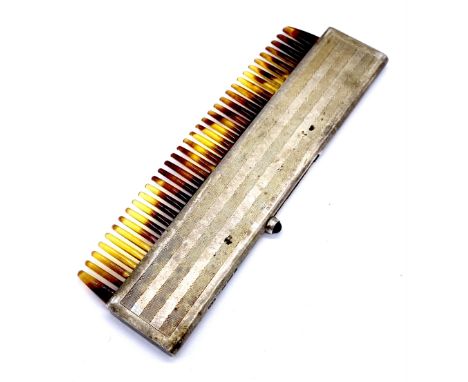 A vintage sterling silver 925 marked travel comb with cabochon sapphire set slide action.