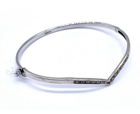 A vintage 9ct white gold wishbone shape hinged bangle set with diamond accents, 6.5cm internal measurement, 6.1 g total weigh