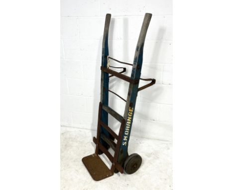 A large pair of vintage sack trucks named to S.M Orange