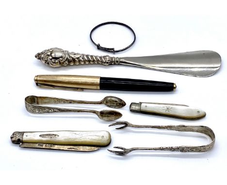 Two silver and mother of pearl fruit knives, silver mounted shoe horn, a parker pen , two pairs of silver sugar nips and a si