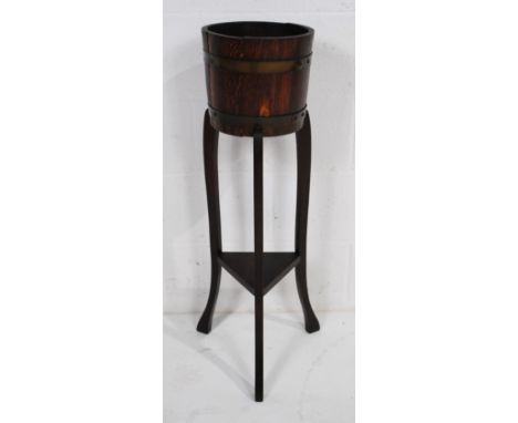 An antique brass bound oak jardiniere plant stand by R. A. Lister & Co. Ltd. of Dursley - diameter 26cm, height 91cm
