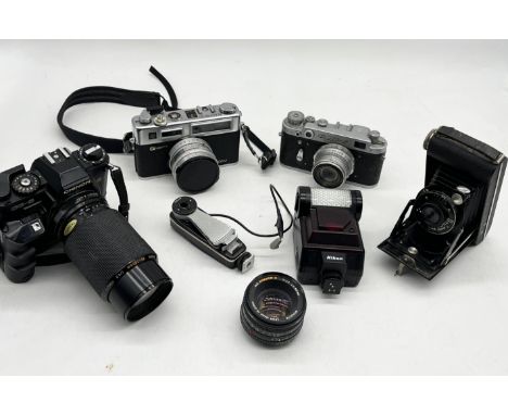 A collection of vintage cameras, lenses and accessories including Chinon CG-5, Yaschica Electro 35, USSR Fed-2 etc.
