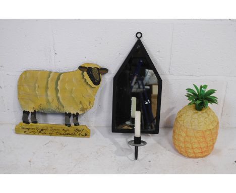 A vintage plastic box in the form of a pineapple, along with a metal framed wall mirror with candelabra and a painted wooden 